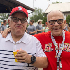 Two St. Louis Cardinal fans enjoy a sunny day.