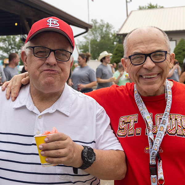 Two St. Louis Cardinal fans enjoy a sunny day.
