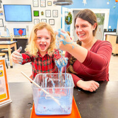 A mother and her daughter play with ooblech.