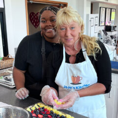 Donor Service Manager Lori Shumake and 2026 Pershing Fellow Intern Senya Simmons prepare dessert for families at HavenHouse.